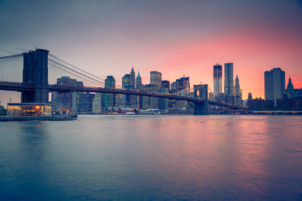 Gorgeous sun setting behind the Brooklyn Bridge